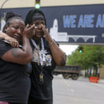 
              Sandra Dees, left, and Marquita Carter cry in front of the Harold K. Stubbs Justice Center, Sunday, July 3, 2022, in Akron, Ohio, after viewing the body cam footage of Jayland Walker's fatal shooting by Akron Police. (Phil Masturzo/Akron Beacon Journal via AP)
            