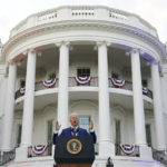 
              FILE - President Joe Biden speaks during an Independence Day celebration on the South Lawn of the White House, July 4, 2021, in Washington. Last Fourth of July, Biden gathered hundreds of people outside the White House for an event that would have been unthinkable for many Americans the previous year. With the coronavirus in retreat, they ate hamburgers and watched fireworks over the National Mall. (AP Photo/Patrick Semansky, File)
            