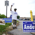 
              Valerie Sligh, a worker in Baltimore Sheriff John Anderson's re-election campaign, canvases outside of a polling place at Edmondson Westside High School during Maryland's primary election, Tuesday, July 19, 2022, in Baltimore. (AP Photo/Julio Cortez)
            