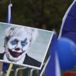 
              FILE - Anti-Brexit demonstrators hold a placard showing current Prime Minister Boris Johnson as the Joker while they take part in a "People's Vote" protest march, in London, Oct. 19, 2019. Outgoing U.K. Prime Minister Boris Johnson has been the bane of Brussels for many years, from his days stoking anti-European Union sentiment with exaggerated newspaper stories to his populist campaign leading Britain out of the bloc and reneging on the post-Brexit trade deal he himself signed. (AP Photo/Matt Dunham, file)
            