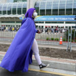 
              Monica Radin of San Diego, dressed as the Raven character in the animated television series "Teen Titans," walks outside Preview Night at the 2022 Comic-Con International at the San Diego Convention Center, Wednesday, July 20, 2022, in San Diego. (AP Photo/Chris Pizzello)
            
