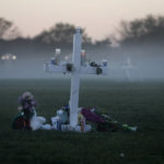 
              FILE - In this Feb. 17, 2018, file photo, an early morning fog rises where 17 memorial crosses were placed for the 17 students and faculty killed in the shooting at Marjory Stoneman Douglas High School in Parkland, Fla. The 12 jurors and 10 alternates chosen this past week to decide whether Cruz is executed will be exposed to horrific images and emotional testimony, but must deal with any mental anguish alone. (AP Photo/Gerald Herbert, File)
            