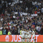 
              FILE - England's team players celebrate after scoring their side's second goal during the Women Euro 2022 semi final soccer match between England and Sweden at the Bramall Lane Stadium in Sheffield, England, Tuesday, July 26, 2022. The march to Sunday's final against Germany has energized people throughout England, with the team's pinpoint passing and flashy goals attracting record crowds, burgeoning TV ratings and adoring coverage. The Lionesses, as the team is known, have been a welcome distraction from the political turmoil and cost-of-living crisis that dominate the headlines. (AP Photo/Rui Vieira, File)
            