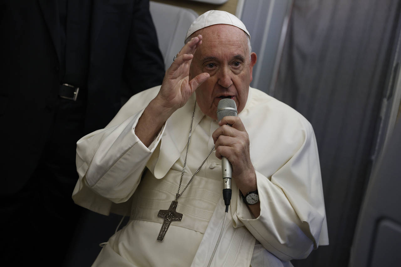 Pope Francis speaks to journalists aboard the papal flight back from Canada Saturday, July 30, 2022...