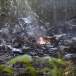 
              A flame is seen amid debris of an Antonov cargo plane in Palaiochori village in northern Greece, Sunday, July 17, 2022, after it reportedly crashed Saturday near the city of Kavala. The An-12, a Soviet-built turboprop aircraft operated by the Ukrainian cargo carrier Meridian, crashed late Saturday as Greek Civil Aviation authorities said the flight was heading from Serbia to Jordan. (AP Photo/Giannis Papanikos)
            