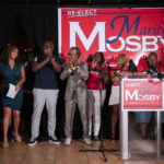 
              Baltimore State's Attorney Marilyn Mosby, left, prepares to speak to supporters and campaign workers on primary night, Tuesday, July 19, 2022, in Baltimore. Mosby was in a three-way Democratic primary as she seeks a third term. (Vincent Alban/The Baltimore Sun via AP)
            