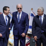 
              President Joe Biden stands with Israeli Prime Minister Yair Lapid, right, and President Isaac Herzog, left, after arriving at Ben Gurion Airport, Wednesday, July 13, 2022, in Tel Aviv. (AP Photo/Evan Vucci)
            
