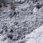 
              Debris and blocks of ice are seen on the Punta Rocca glacier near Canazei, in the Italian Alps in northern Italy, Tuesday, July 5, 2022, two days after a huge chunk of the glacier broke loose, sending an avalanche of ice, snow, and rocks onto hikers. Italy was enduring a prolonged heat wave before a massive piece of the Alpine glacier broke off and killed hikers on Sunday and experts say climate change will make those hot, destabilizing conditions more common. (AP Photo/Luca Bruno)
            
