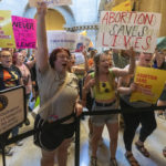 
              A loud group standing outside the Indiana Senate chambers chant about their desire for abortion rights, Monday, July 25, 2022, during the Indiana Statehouse's special session. (Robert Scheer/The Indianapolis Star via AP)
            
