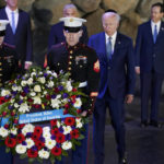 
              President Joe Biden, wearing a skullcap, participates in a wreath laying ceremony in the Hall of Remembrance at Yad Vashem, Wednesday, July 13, 2022, in Jerusalem. (AP Photo/Evan Vucci)
            