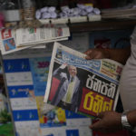 
              A man holds a newspaper with news of Ranil Wickremesinghe's election in Colombo, Sri Lanka, Thursday, July 21, 2022. Sri Lanka's prime minister was elected president Wednesday by lawmakers who opted for a seasoned, veteran leader to lead the country out of economic collapse, despite widespread public opposition. (AP Photo/Rafiq Maqbool)
            