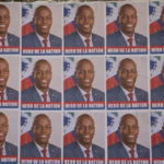 
              Posters of slain Haitian President Jovenel Moise that reads "National Hero" cover a wall in the Petion-ville area of Port-au-Prince, Haiti, Thursday, July 7, 2022. A year has passed since Moise was assassinated at his private home. (AP Photo/Odelyn Joseph)
            