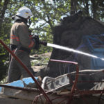 
              Ukrainian State Emergency Service firefighter works to extinguish a fire at at damaged residential building in the town of Serhiivka, located about 50 kilometers (31 miles) southwest of Odesa, Ukraine, Friday, July 1, 2022. Russian missile attacks on residential areas in a coastal town near the Ukrainian port city of Odesa early Friday killed at least 19 people, authorities reported, a day after Russian forces withdrew from a strategic Black Sea island. (AP Photo/Nina Lyashonok)
            