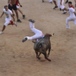 
              A man is tossed by a calf in the bullring after the running of the bulls at the San Fermin Festival in Pamplona, northern Spain, Wednesday, July 13, 2022. Revellers from around the world flock to Pamplona every year for nine days of uninterrupted partying in Pamplona's famed running of the bulls festival which was suspended for the past two years because of the coronavirus pandemic. (AP Photo/Alvaro Barrientos)
            