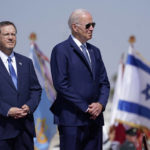 
              President Joe Biden stands with Israeli President Isaac Herzog, left, after arriving at Ben Gurion Airport, Wednesday, July 13, 2022, in Tel Aviv. (AP Photo/Evan Vucci)
            