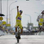 
              Belgium's Wout Van Aert, wearing the overall leader's yellow jersey celebrates as he crosses the finish line to win the fourth stage of the Tour de France cycling race over 171.5 kilometers (106.6 miles) with start in Dunkerque and finish in Calais, France, Tuesday, July 5, 2022. (AP Photo/Daniel Cole)
            