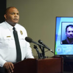 
              Richmond Police Chief Gerald M Smith listens to a question in front of a photo of one of two suspects during a press conference at Richmond Virginia Police headquarters Wednesday July 6, 2022, in Richmond, Va. Police said Wednesday that they thwarted a planned July 4 mass shooting after receiving a tip that led to arrests and the seizure of multiple guns — an announcement that came just two days after a deadly mass shooting on the holiday in a Chicago suburb.  (AP Photo/Steve Helber)
            