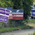 
              Election yard signs line a sidewalk in Cheyenne, Wyo., on Tuesday, July 19, 2022. One of the most closely watched races pits Harriet Hageman against incumbent Rep. Liz Cheney, R-Wyo., in the Aug. 16 Republican primary. (AP Photo/Thomas Peipert)
            