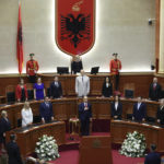 
              Newly appointed Albanian President Bajram Begaj stands for the national anthem during a swearing in ceremony at the parliament in Tirana, Sunday, July 24, 2022. Albania's new president sworn in on Sunday calling on the country's political parties to cooperate and consolidate the rule of law. (AP Photo/Franc Zhurda)
            