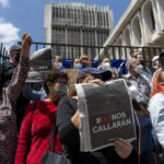 
              Journalists gather outside a court in protest against the detention of award-winning journalist Jose Ruben Zamora, who was arrested the day before, in Guatemala City, Saturday, July 30, 2022. Politicians, anti-corruption activists and civic groups condemned the Guatemalan government’s decision to arrest the investigative journalist, who heads the newspaper El Periodico, which specializes in uncovering corruption. (AP Photo/Moises Castillo)
            