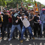 
              Protesters shout slogans before storming the Sri Lankan Prime Minister Ranil Wickremesinghe's office, demanding he resign after president Gotabaya Rajapaksa fled the country amid economic crisis in Colombo, Sri Lanka, Wednesday, July 13, 2022. Sri Lanka’s president fled the country without stepping down Wednesday, plunging a country already reeling from economic chaos into more political turmoil. Protesters demanding a change in leadership then trained their ire on the prime minister and stormed his office. (AP Photo/ Photo/Rafiq Maqbool)
            