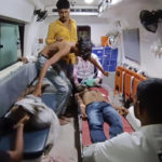 
              People wait to be carried into a hospital for treatment after falling sick from consuming spurious liquor in Botad, India, Tuesday, July 26, 2022. At least 21 people have died and another 30 fallen sick from drinking spurious liquor in India's western state of Gujarat, officials said Tuesday. Senior government official Mukesh Parmar said the deaths occurred in Ahmedabad and Botad districts of the state, where manufacturing, sale and consumption of liquor are prohibited. (AP Photo)
            