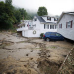 
              A house that was moved off of its foundation following a flash flood rests on top of a vehicle, Thursday, July 14, 2022 in Whitewood, Va. Virginia Gov. Glenn Youngkin declared a state of emergency to aid in the rescue and recovery efforts from Tuesday's floodwaters. (AP Photo/Michael Clubb)
            