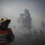 
              A firefighter takes position as smoke rises at a forest fire near Louchats, 35 kms (22 miles) from Landiras in Gironde, southwestern France, Monday, July 18, 2022. France scrambled more water-bombing planes and hundreds more firefighters to combat spreading wildfires that were being fed Monday by hot swirling winds from a searing heat wave broiling much of Europe. With winds changing direction, authorities in southwestern France announced plans to evacuate more towns and move out 3,500 people at risk of finding themselves in the path of the raging flames. (Philippe Lopez/Pool Photo via AP)
            