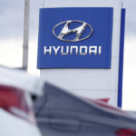 
              FILE - The Hyundai company logo hangs over a long row of cars at a car dealership in Centennial, Colo., Sunday, Dec. 20, 2020. Georgia officials are close to finalizing a deal with the automaker to build a $5.5 billion electric car plant near Savannah, Ga. An economic development agency representing four Savannah-area counties approved its portions of the agreement Tuesday, July 19, 2022, including an economic incentives package. (AP Photo/David Zalubowski, File)
            