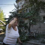 
              FILE - A woman reacts after the Russian shelling in city center in Slovyansk, Donetsk region, Ukraine, Monday, June 27, 2022. (AP Photo/Efrem Lukatsky)
            