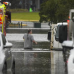 
              A man walks through flood waters back to his home from a fire truck at Windsor on the outskirts of Sydney, Australia, Tuesday, July 5, 2022. Hundreds of homes have been inundated in and around Australia’s largest city in a flood emergency that was threatening 50,000 people, officials said on Tuesday. (AP Photo/Mark Baker)
            