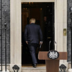 
              Prime Minister Boris Johnson enters 10 Downing Street, after reading a statement in London, Thursday, July 7, 2022. Johnson said Thursday he will remain as British prime minister while a leadership contest is held to choose his successor. (AP Photo/Alberto Pezzali)
            