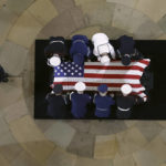 
              The flag-draped casket bearing the remains of Hershel W. “Woody” Williams is carried by joint service members into the U.S. Capitol Rotunda, Thursday, July 14, 2022 in Washington, to lie in honor.  Williams, the last remaining Medal of Honor recipient from World War II, died at age 98. (Chip Somodevilla/Pool Photo via AP)
            
