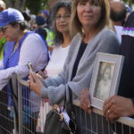 
              CORRECTS SPELLING OF LAST NAME TO GLADUE INSTEAD OF GLADE - Gerald Gladue holds a photo of his mom Jeannie Gladue, who was a residential school survivor, while waiting for Pope Francis' arrival at the Sacred Heart Church of the First People, in Edmonton, Alberta, during his Papal visit across Canada on Monday July 25, 2022. Pope Francis apologized to the Indigenous communities for the Roman Catholic Church's role in the residential school system. (Jason Franson./The Canadian Press via AP)
            