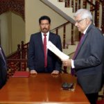 
              In this photograph provided by the Sri Lankan President's Office, Ranil Wickremesinghe takes oath as the interim President in Colombo, Sri Lanka, Friday, July 15, 2022. Prime Minister Wickremesinghe was sworn in as Sri Lanka's interim president Friday until Parliament elects a successor to Gotabaya Rajapaksa, who resigned after mass protests over the country's economic collapse forced him from office. (Sri Lankan President's Office via AP)
            