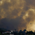 
              A helicopter launches water as a wildfire advances near a residential area, in Alhaurin de la Torre, Malaga, Spain, Saturday, July 16, 2022. Wildfires continue to spread across Spain as firefighters work to bring them under control. (AP Photo/Gregorio Marrero)
            