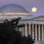 
              A full moon sets behind the Jefferson Memorial in Washington at dawn, Thursday, July 14, 2022. (AP Photo/J. David Ake)
            