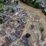 
              FILE - Debris of a flood lies between destroyed houses near the Ahr river in Schuld, Germany, July 15, 2021. Due to heavy rain falls the Ahr river dramatically went over the banks the evening before. (AP Photo/Michael Probst, File)
            