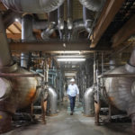 
              Intermountain Power Agency spokesperson John Ward walks through a coal power plant on Wednesday, June 22, 2022, in Delta, Utah. Developers in rural Utah who want to create big underground caverns to store hydrogen fuel won a $504 million loan guarantee this spring. They plan to convert the site of the 40-year-old coal plant to cleanly-made hydrogen by 2045. (AP Photo/Rick Bowmer)
            