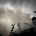 
              A rescue worker puts out the fire on a destroyed house after a Russian attack in a residential neighborhood in downtown Kharkiv, Ukraine, on Monday, July 11, 2022.  The top official in the Kharkiv region said Monday the Russian forces launched three missile strikes on the city targeting a school, a residential building and warehouse facilities. (AP Photo/Evgeniy Maloletka)
            