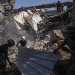 
              Rescue workers clearing rubble of destroyed house after a Russian attack in a residential neighborhood in downtown Kharkiv, Ukraine, on Saturday, July 9, 2022. (AP Photo/Evgeniy Maloletka)
            