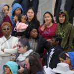 
              People wait a meeting with Pope Francis at Nakasuk Elementary School Square in Iqaluit, Canada, Friday, July 29, 2022. Pope Francis travels to chilly Iqaluit, capital of northern Nunavut, to meet with Inuit Indigenous people, including school children and survivors of residential schools, in his final day in Canada. (AP Photo/Gregorio Borgia)
            