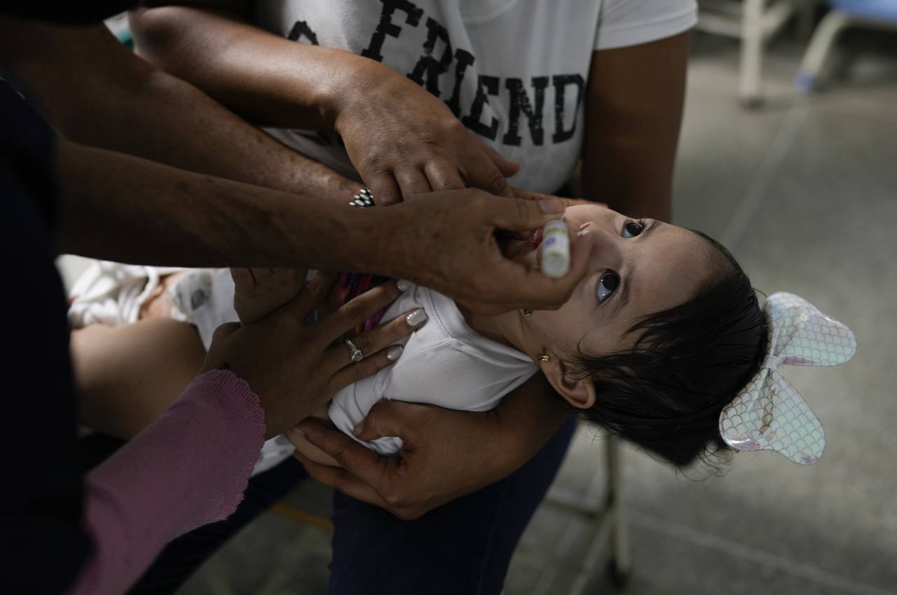 A toddler is inoculated for polio during a free vaccination campaign for polio, rubella and influen...
