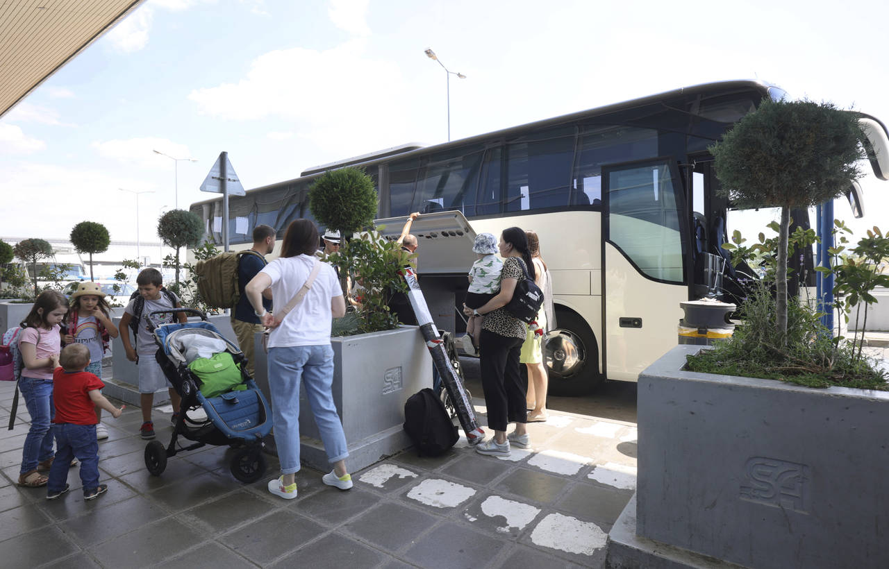 Russian diplomatic staff arrive on a bus at Sofia's Airport, Bulgaria, Sunday, July 3 2022. Two Rus...
