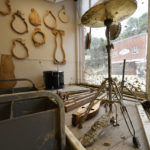 
              The high water mark from floodwaters from Troublesome Creek mark the wall below instrument forms hanging on the wall at the Applachian School of Luthery inspects the damage at the workshop and museum in Hindman, Ky., Sunday, July 31, 2022. (AP Photo/Timothy D. Easley)
            