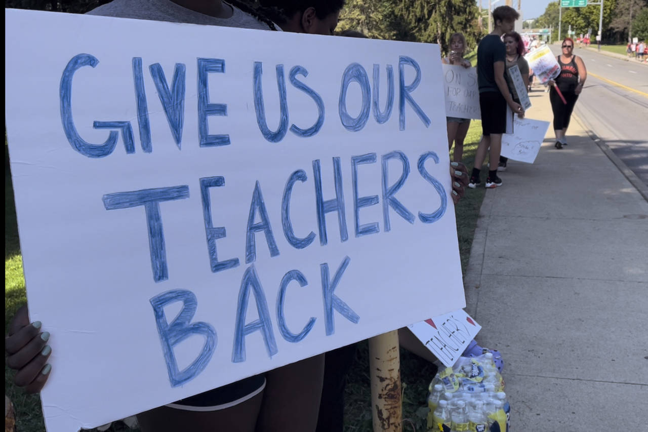 Teachers march on sidewalks outside Whetstone High School in Columbus, Ohio, as part of a district-...