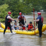 
              Members of the Balch Springs Fire Department bring a family of four, who did not wish to be named, by boat to higher ground after rescuing them from their home along Forest Glen Lane in Balch Springs, Texas, Monday, Aug. 22, 2022. Over 9 inches of rain were reported in the last 24 hours at DFW Airport. (Elías Valverde II/The Dallas Morning News via AP)
            