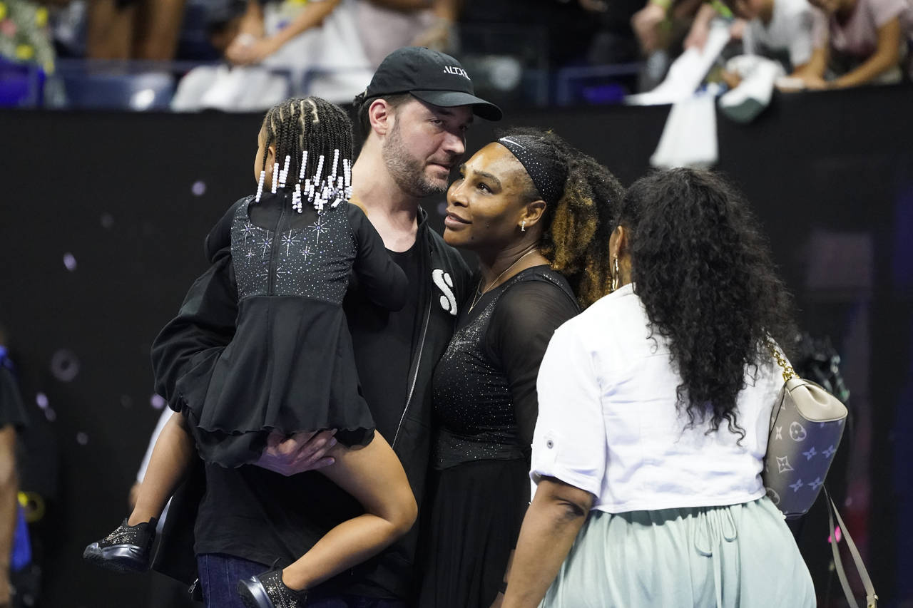 Serena Williams, of the United States, talks with her husband Alexis Ohanian and daughter Olympia a...