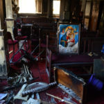 
              Burned furniture, including wooden tables and chairs, and a religious images are seen at the site of a fire inside the Abu Sefein Coptic church that killed at least 40 people and injured some 14 others, in the densely populated neighborhood of Imbaba, Cairo Egypt, Sunday, Aug. 14, 2022. The church said the fire broke out while a service was underway. The cause of the blaze was not immediately known. An initial investigation pointed to an electrical short-circuit, according to a police statement. (AP Photo/Tarek Wajeh)
            