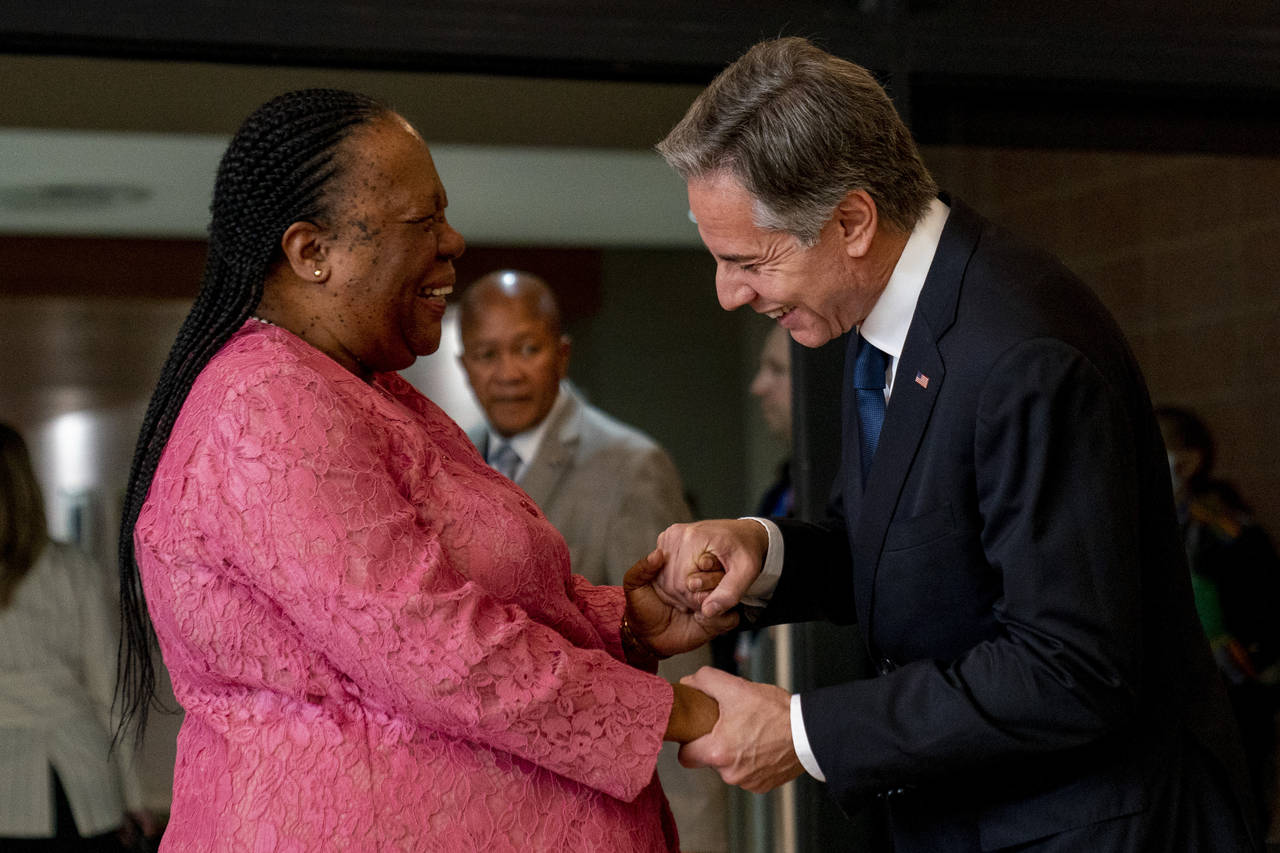 Secretary of State Antony Blinken is greeted by South Africa's Foreign Minister Naledi Pandor as he...